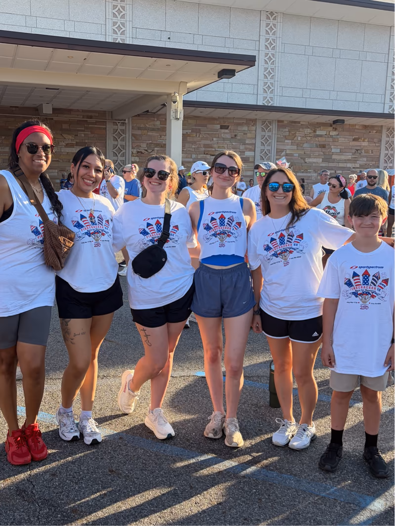 Morris & Dewett team members in their Firecracker 5K race shirts on the morning of the race